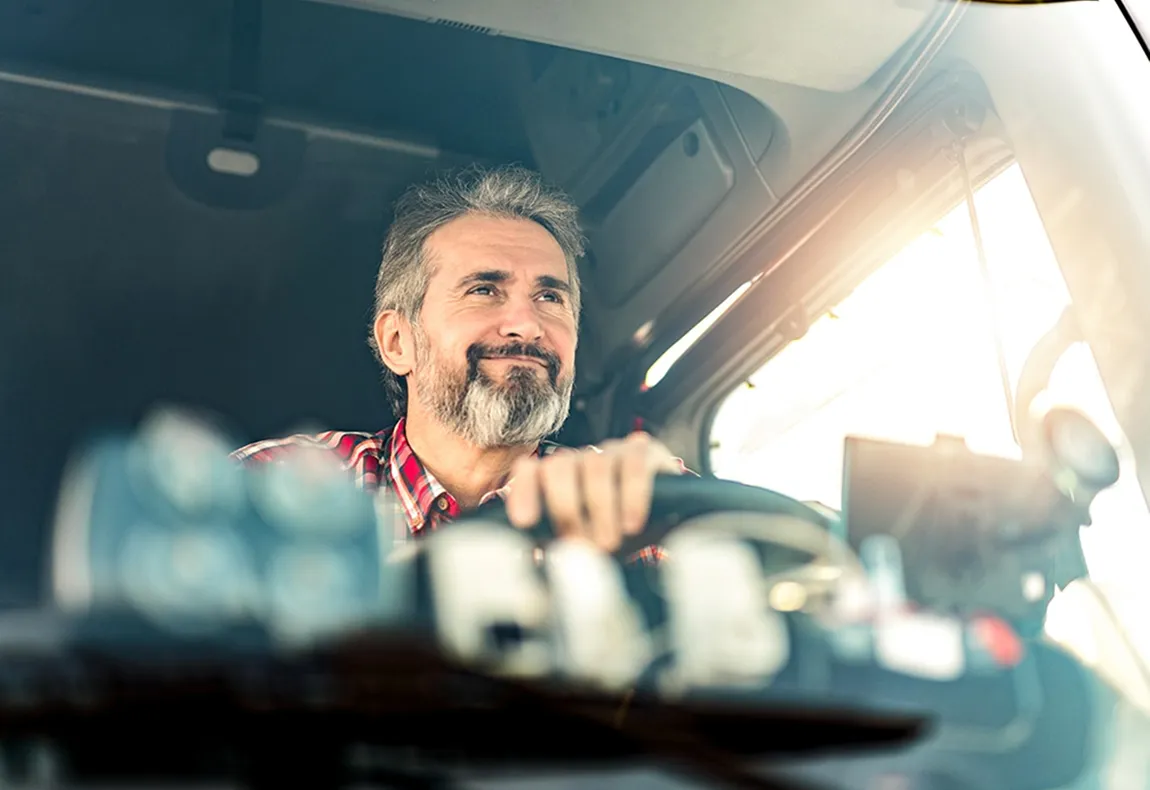 KAG truck driver smiling while driving a tanker truck