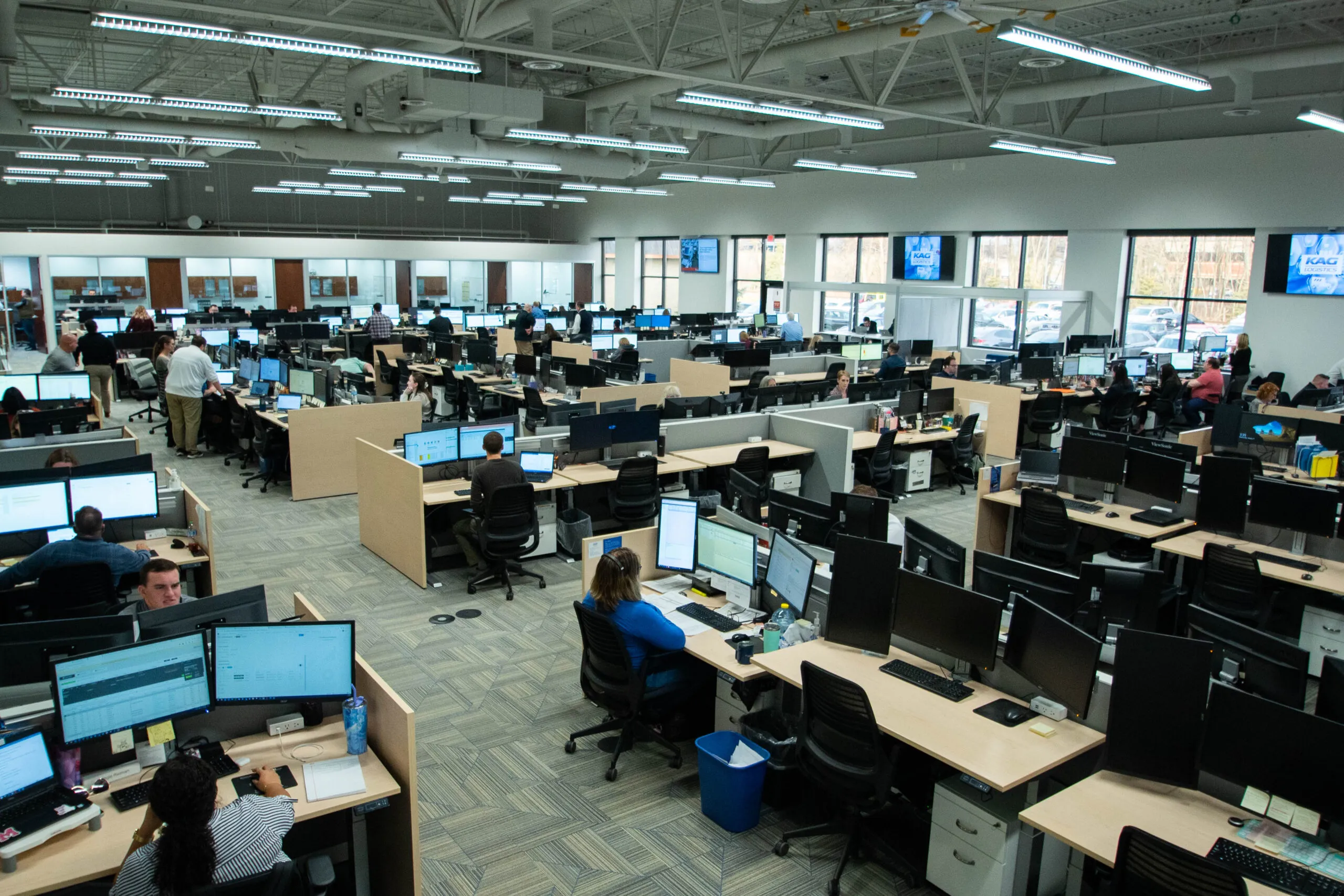 Aerial view of KAG's open-plan logistics operations center with staff at desks