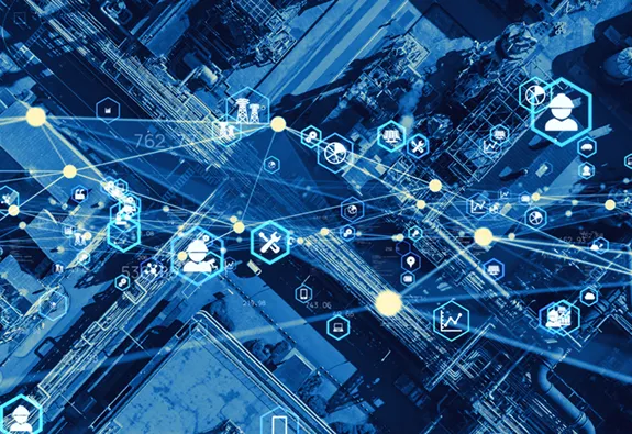 Aerial view of industrial facility overlaid with digital network icons representing smart technology and connected operations