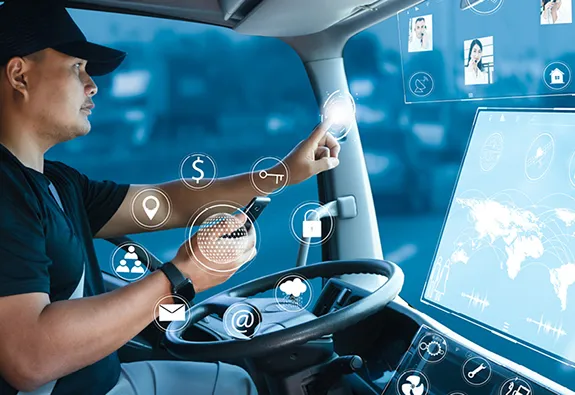 Commercial truck driver interacting with a digital dashboard and connected technology interface inside a modern smart transportation vehicle.