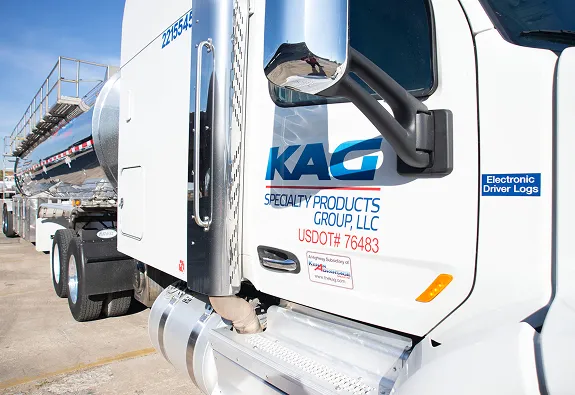 Close-up of a KAG Specialty Products Group LLC tanker truck cab showing USDOT number and Electronic Driver Logs sticker