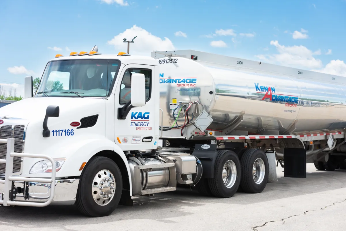 KAG Energy tanker truck with a Kenan Advantage Group polished tanker trailer under a clear blue sky