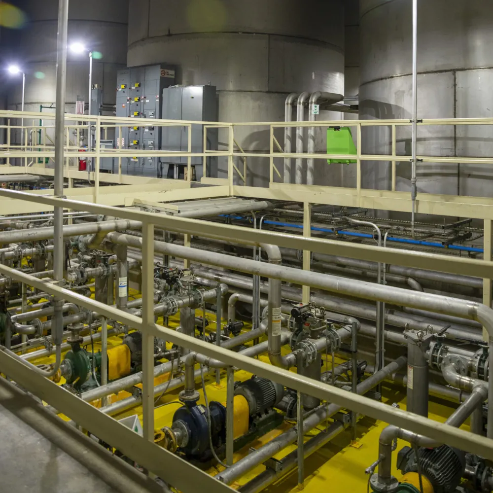 Industrial bulk storage facility with large storage tanks, pumps, and interconnected piping systems used for liquid product handling and distribution.