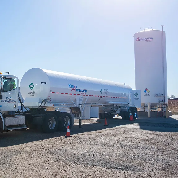 KAG Kenan Advantage tanker truck parked beside a storage tank