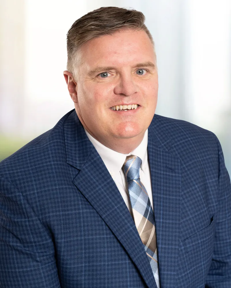 Professional headshot of KAG's president and chief operating officer Grant Mitchell.